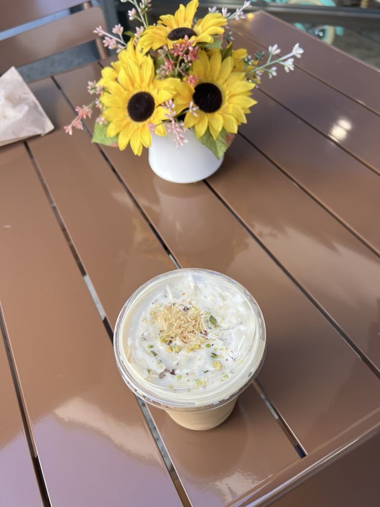 Baklava latte topped with shredded phyllo and pistachio