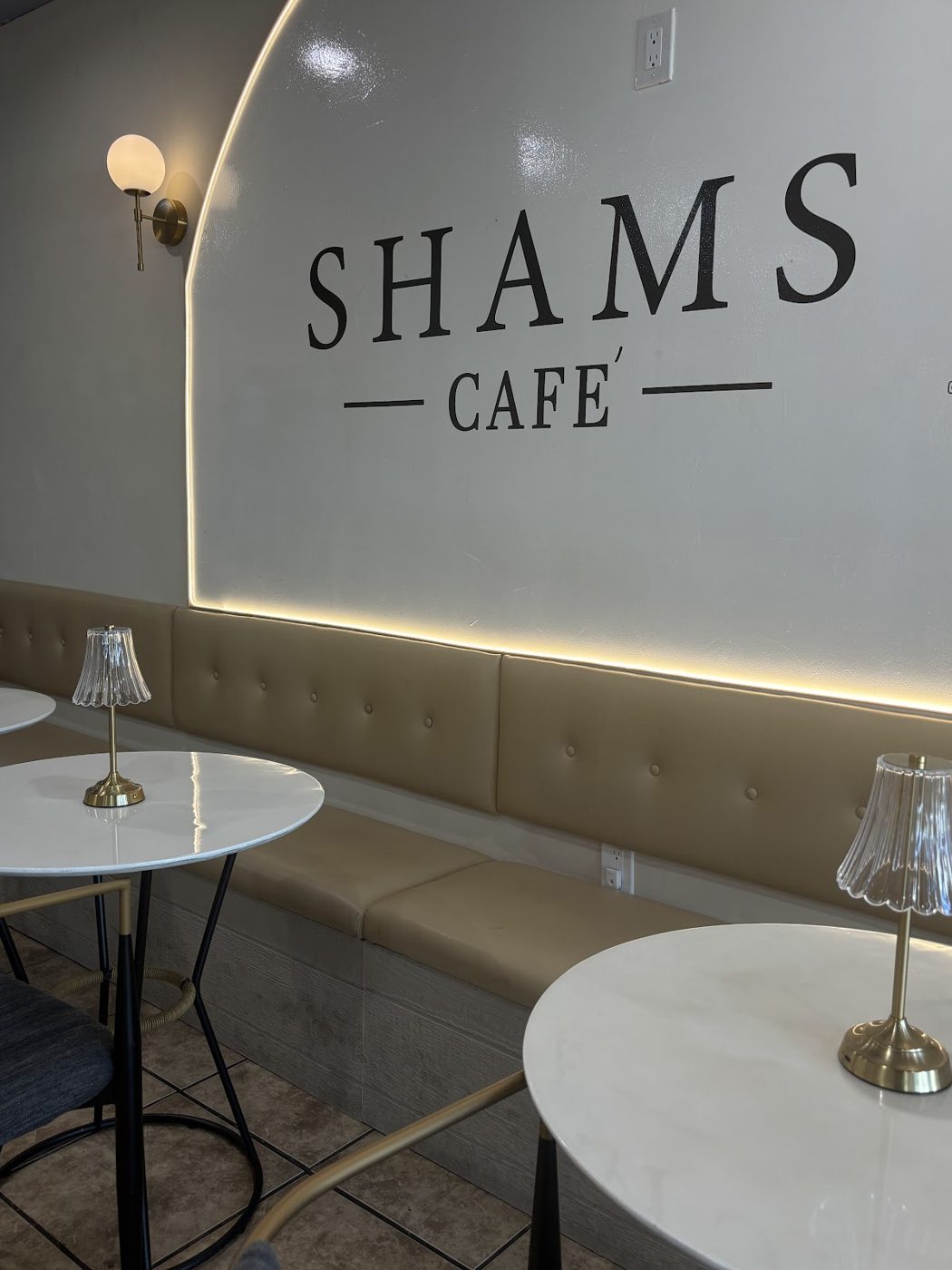 The arched counter and pendant lamps inside Shams Cafe